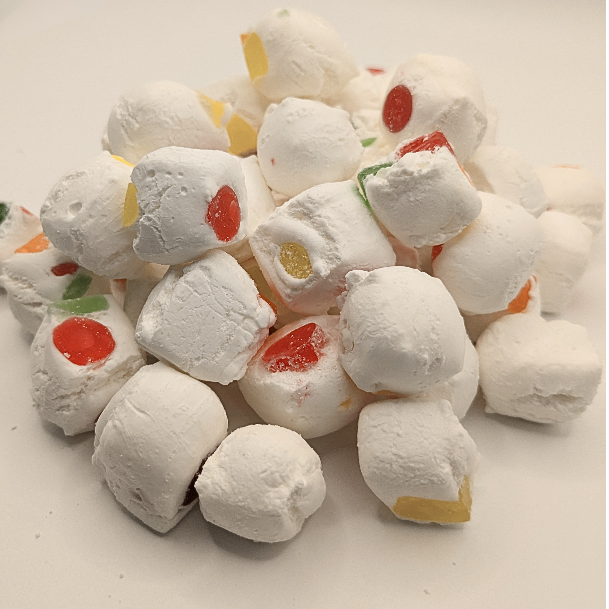 A pile of freeze dried jujube nougats on a white background