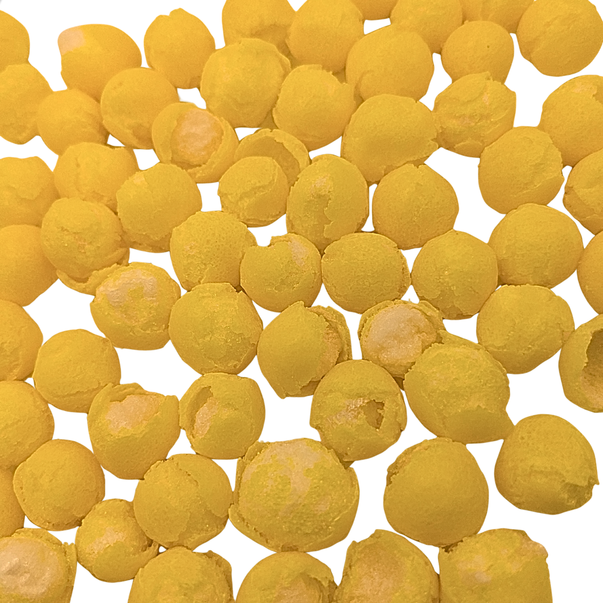A close-up pile of small, round, freeze dried lemon candy on a plain white background.
