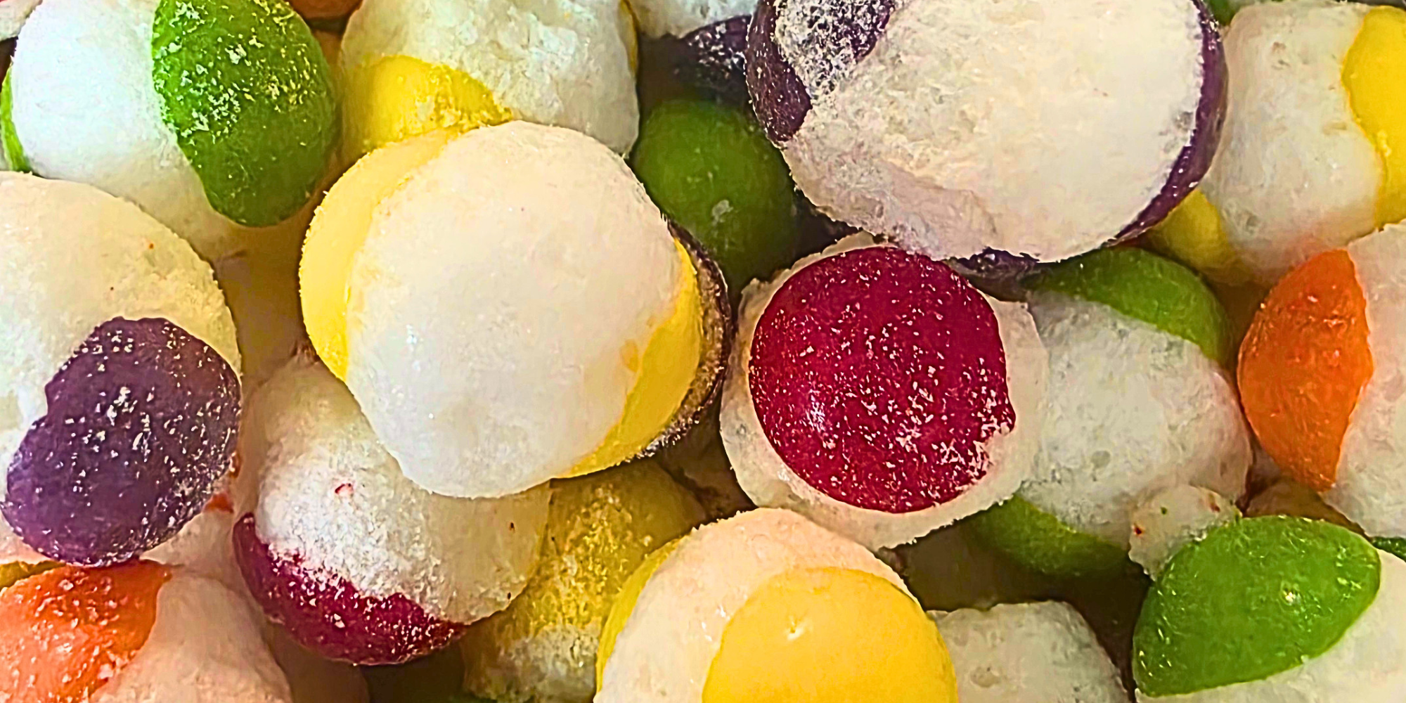 Freeze dried rainbow candy, which has different colored shells that burst out white in the center