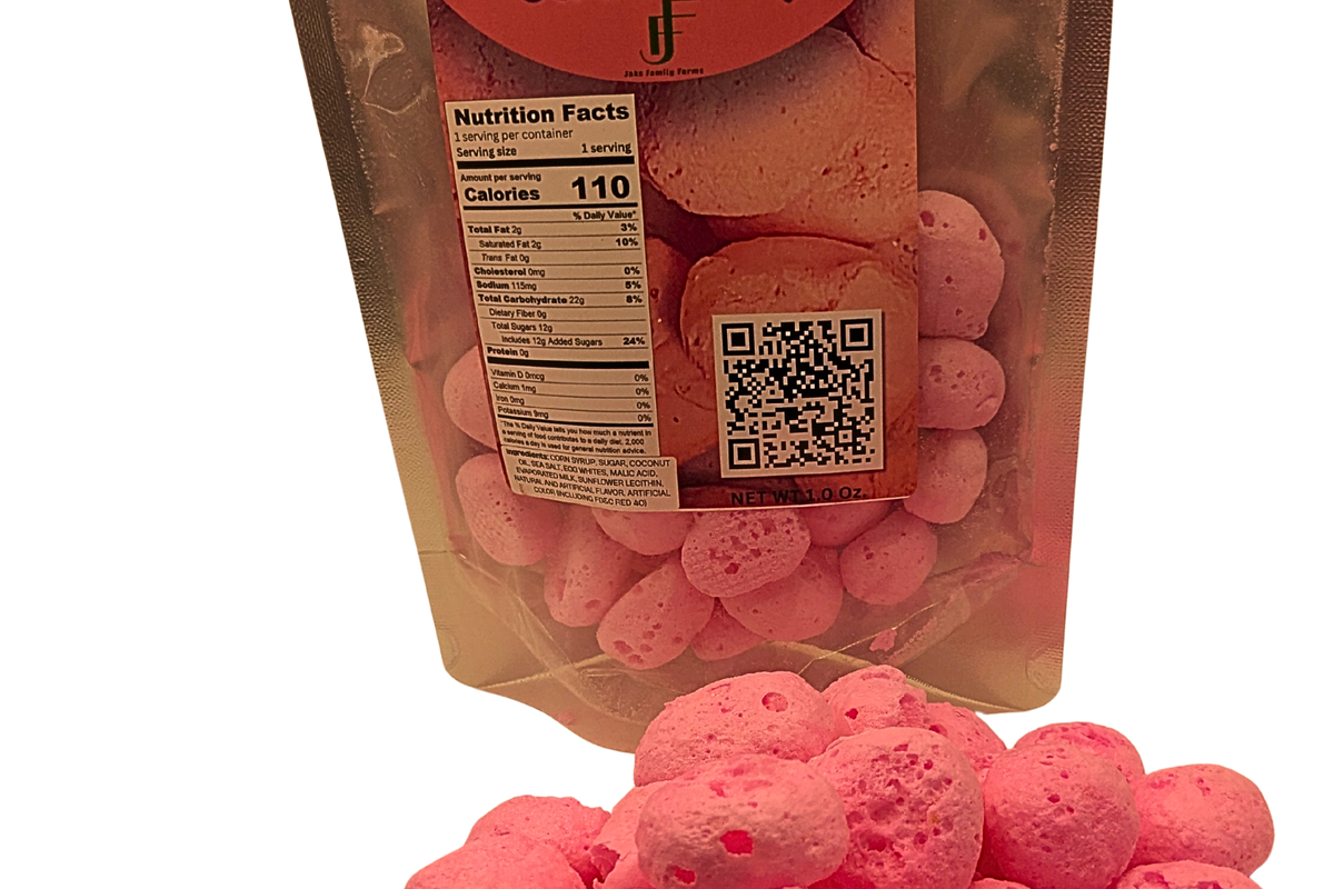 Package of Freeze Dried Strawberry Taffy with a pile of freeze dried taffy in front on a white background
