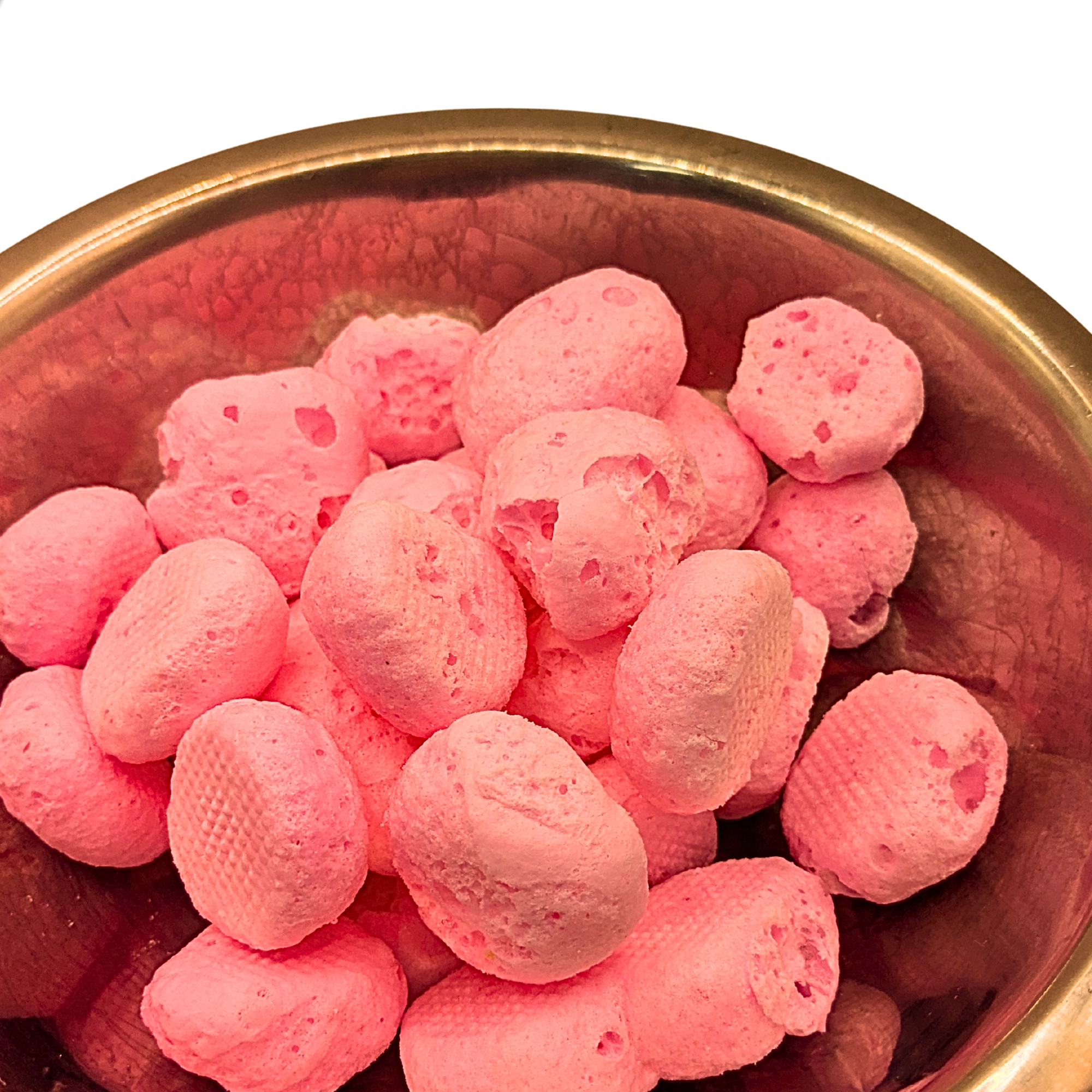 Bowl of freeze dried stawberry taffy against a white background