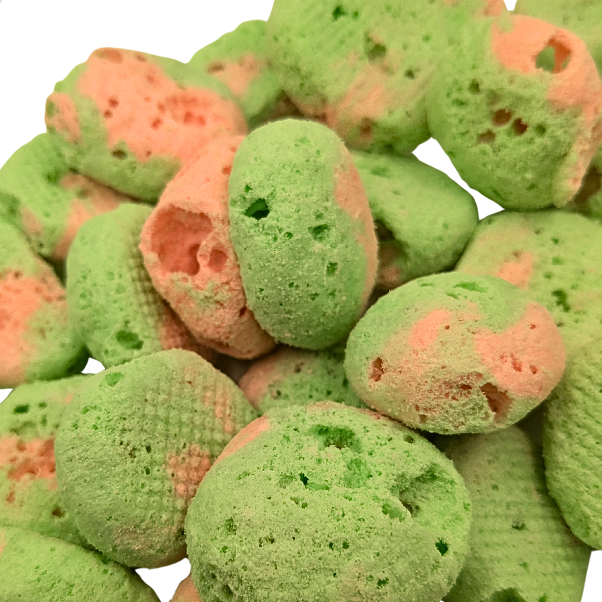 Close up of freeze dried watermelon taffy, which is pink and green with a crunchy texture