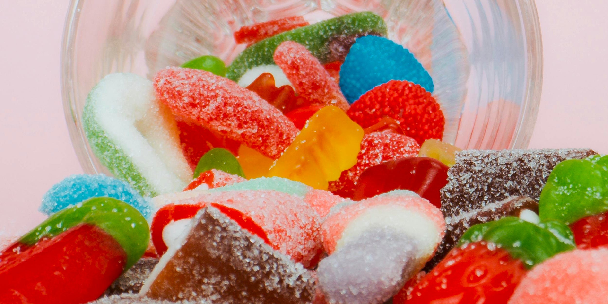 A bowl with colorful candy spilling out