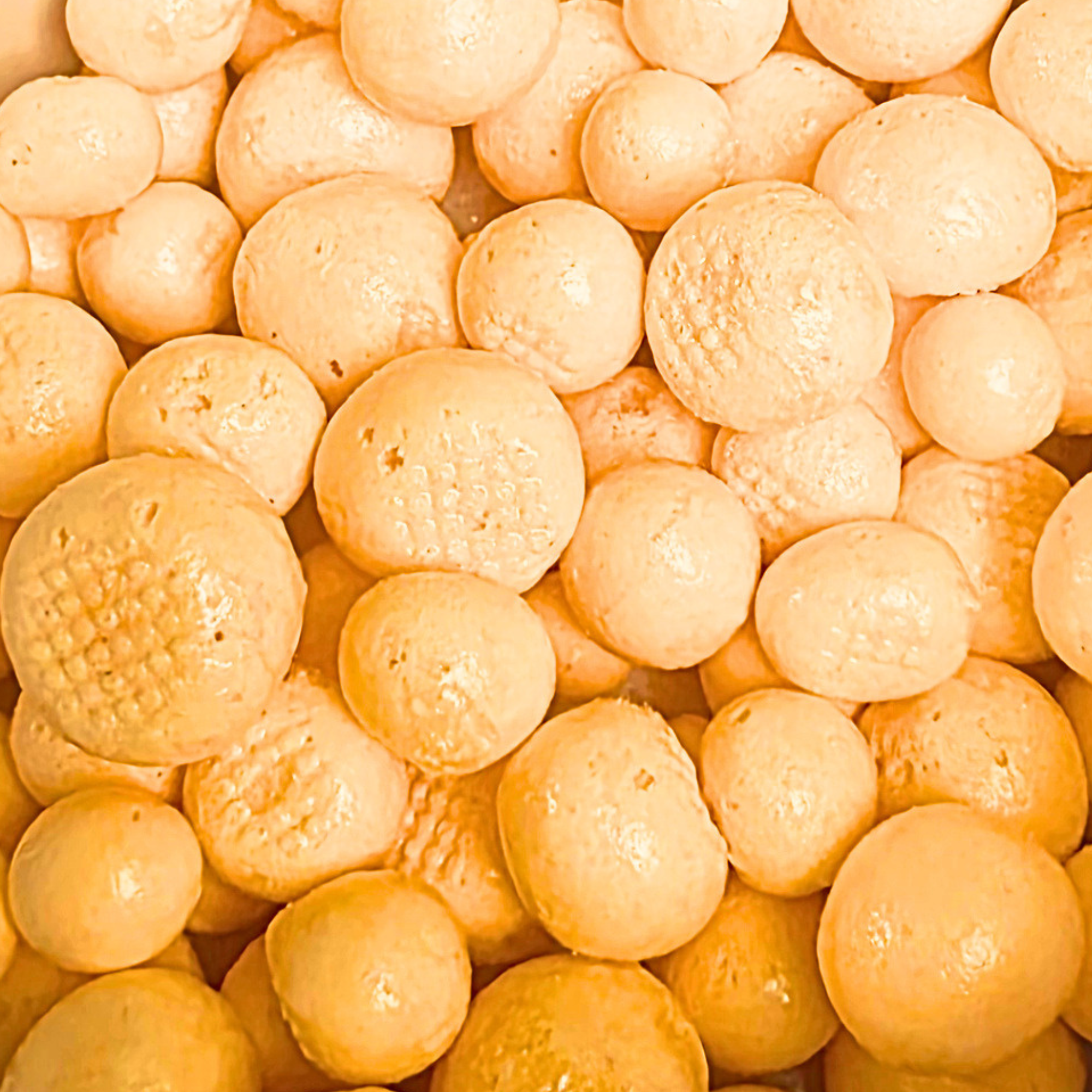 Freeze dried orange taffy, which is fluffy, orange, and round