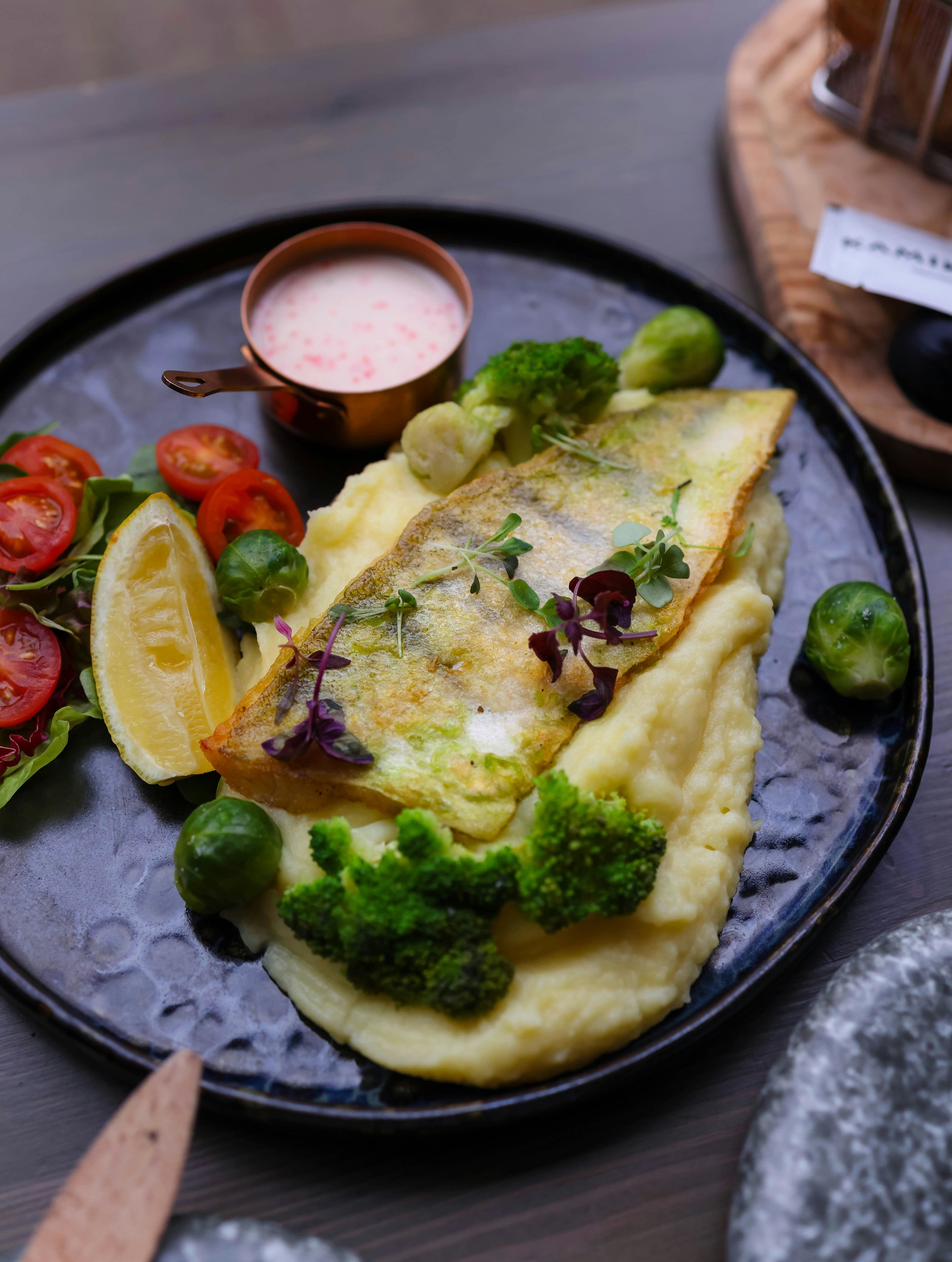 microgreens, broccoli, and brussel sprouts on top of creamy mashed potatoes