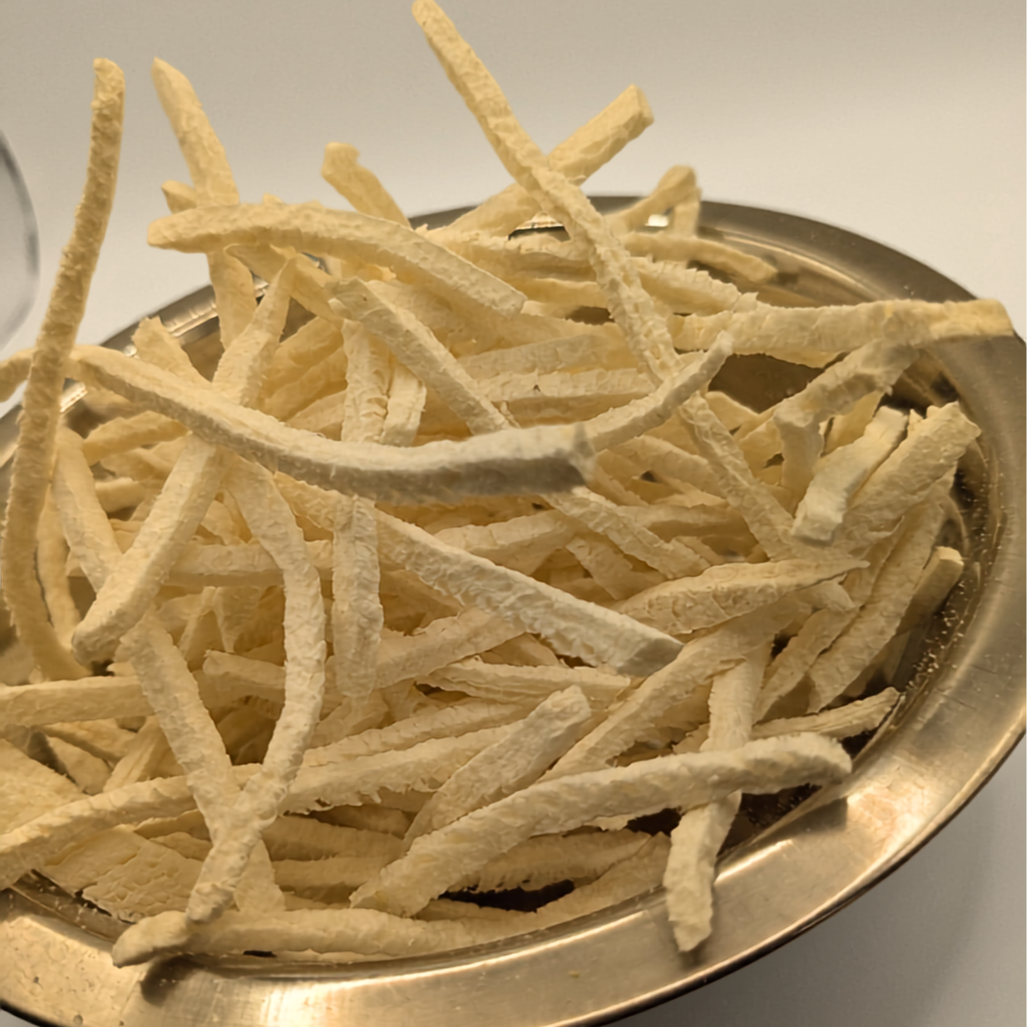 Close up of freeze dried jicama in a metal bowl