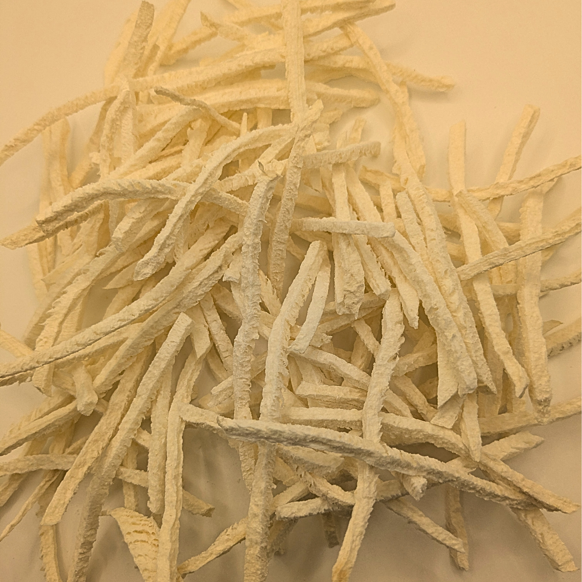 A pile of freeze dried jicama on a white background