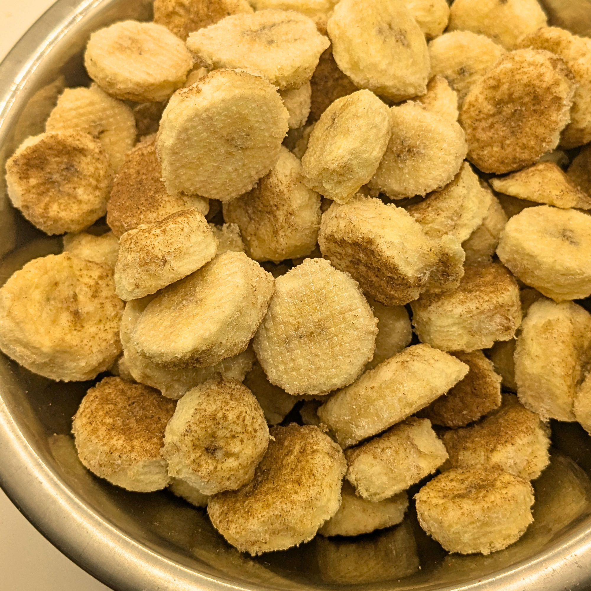 Freeze dried honey cinnamon bananas in a metal bowl