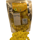 A stand-up pouch of Freeze Dried Lemon Blitz snack mix with yellow freeze-dried pieces spilling out in front on a white background.