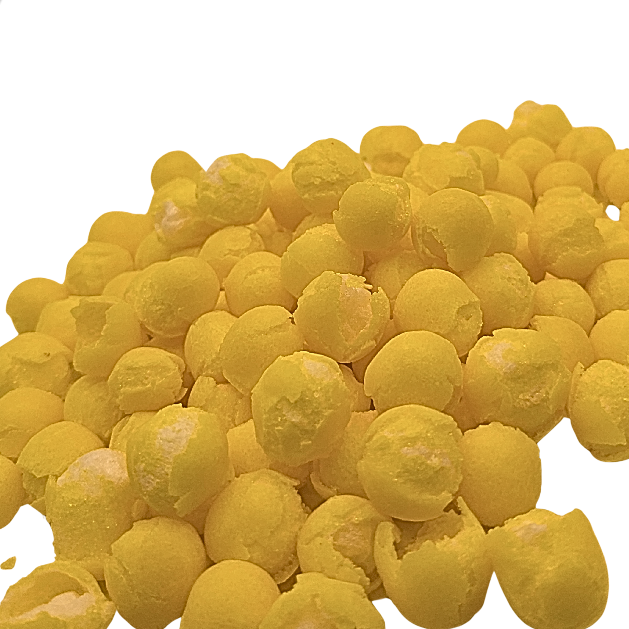 A pile of freeze dried lemon candy on a plain white background.
