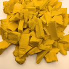 A pile of freeze dried sliced mango, which are yellow with a crunchy-looking texture
