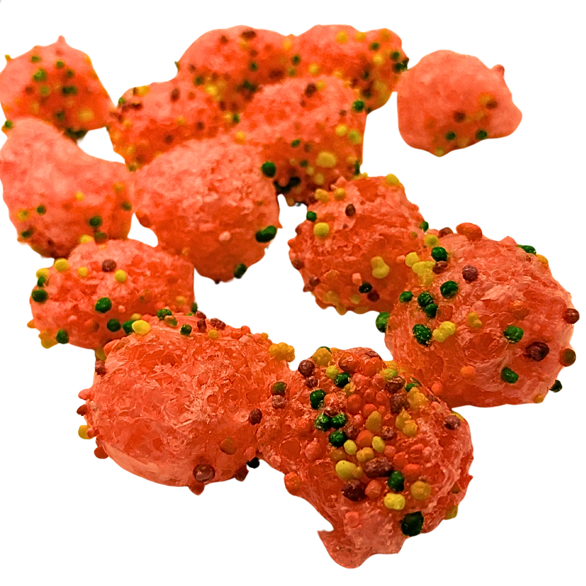 Several pieces of bright orange-red candy sprinkled with multicolored sprinkles, arranged on a plain white background.
