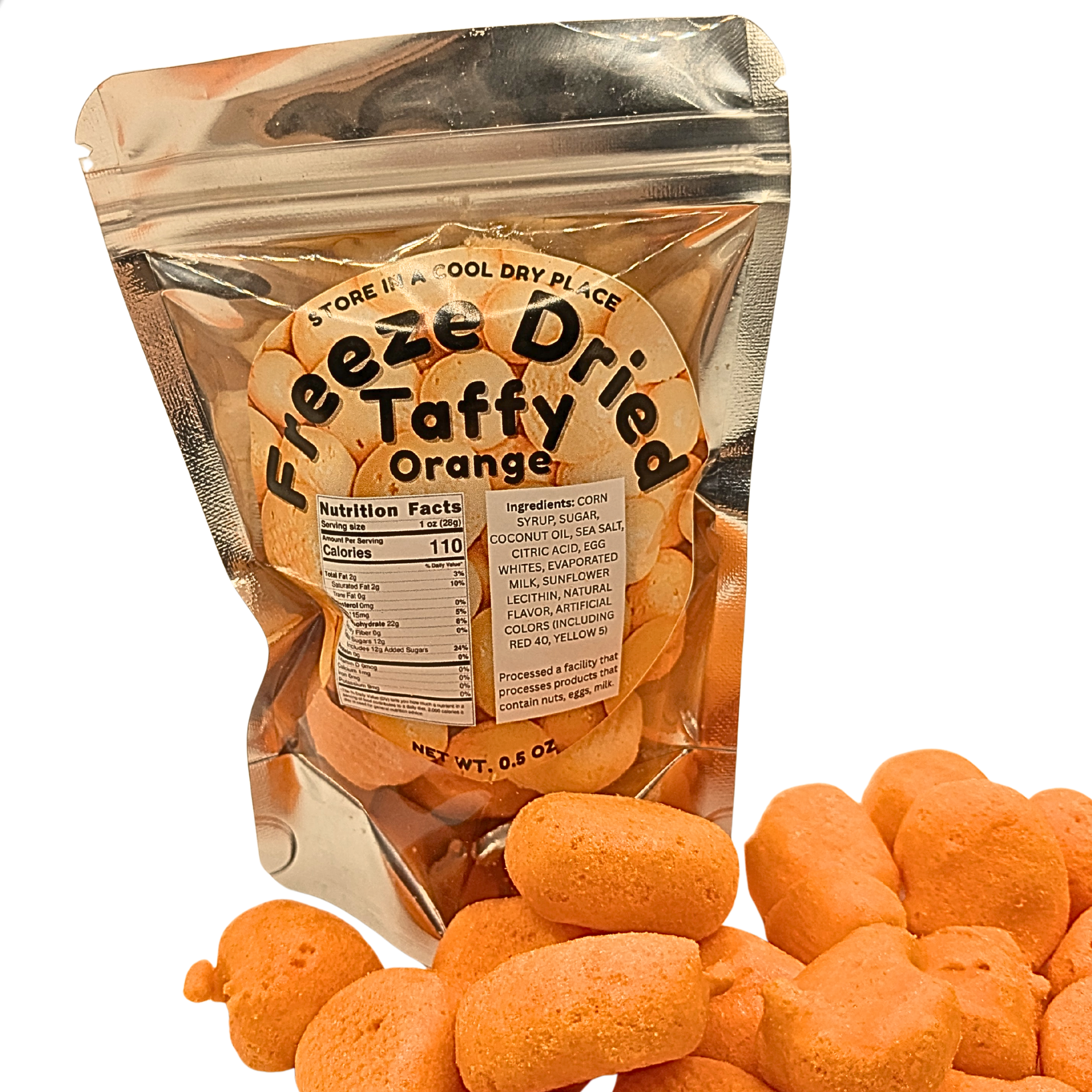 A stand-up pouch of Freeze Dried Taffy Dried Orange snack pieces on a white background, with several orange snack pieces spilled in front. The pouch label reads 'Freeze Dried Taffy Dried Orange' and shows nutrition facts and ingredients.
