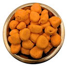 A top-down view of freeze dried orange taffy, piled inside a round metallic bowl on a plain white background.