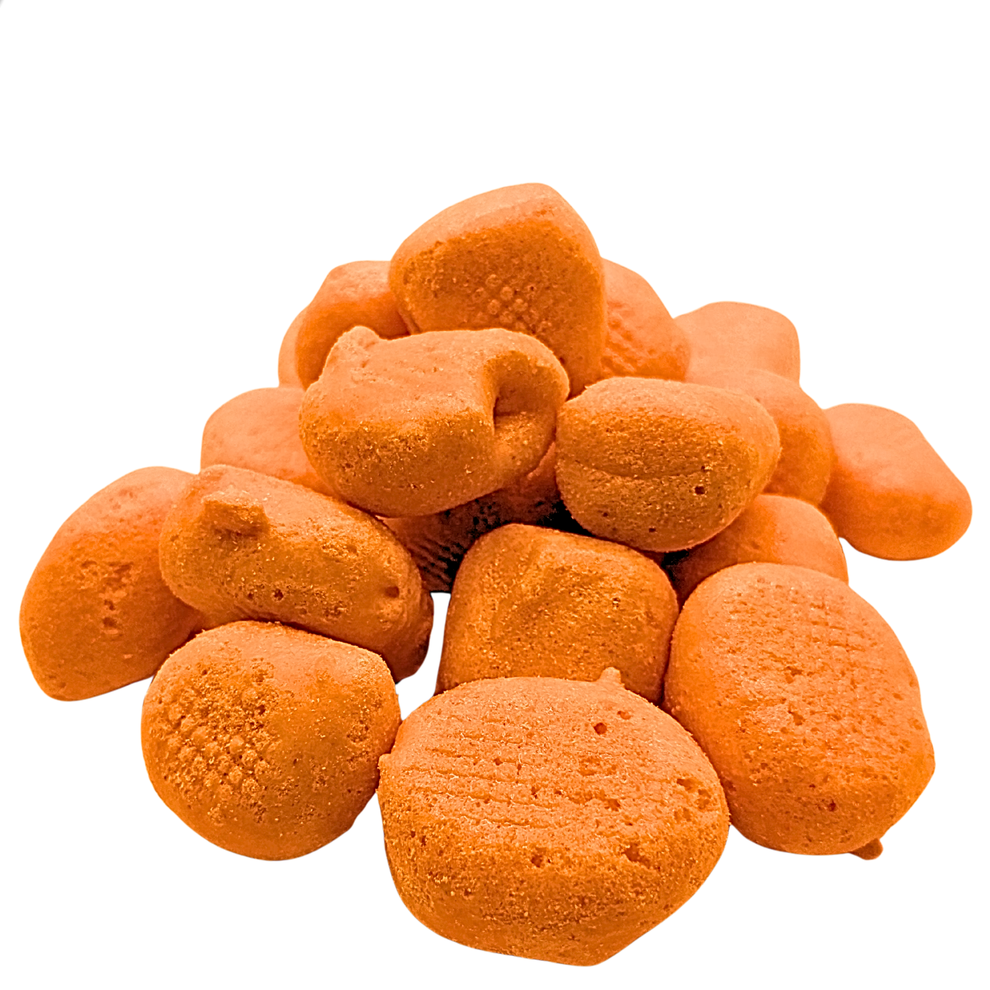 A pile of textured orange freeze dried taffy on a plain white background.