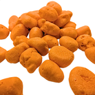 A pile of small, irregularly shaped orange freeze dried taffy isolated on a white backgroud