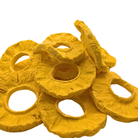 A pile of freeze dried pineapple slices in a bright yellow color, isolated on a white background.