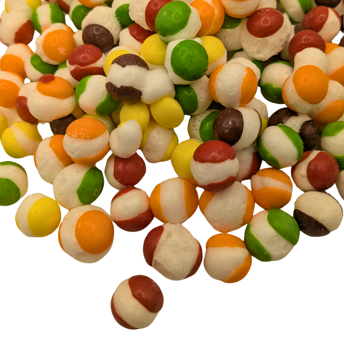 A spread out pile of freeze dried spherical candy with a white center and yellow, orange, red, green, and purple shells 