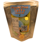 A stand-up pouch of Freeze Dried Taffy Assorted candies, featuring a metallic gold foil bag with a blue label and a clear window showing the colorful freeze-dried taffy pieces inside.