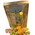 A bag of freeze dried assorted taffy with a pile of the taffy in the front