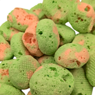 Close up of freeze dried watermelon taffy, which is pink and green with a crunchy texture