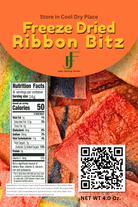 Front packaging panel for Johnake Farm Farms Freeze Dried Ribbon Bitz, featuring a bright orange header with yellow text, a nutrition facts label, a QR code, and a close-up photo of freeze-dried reddish-brown ribbon bits.