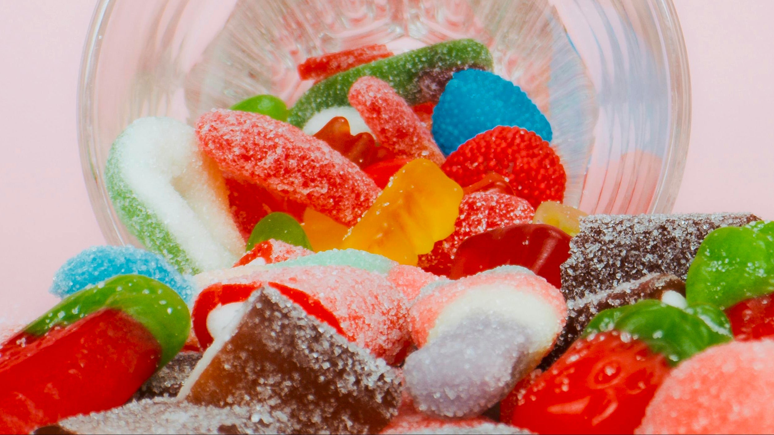 A bowl with colorful candy spilling out