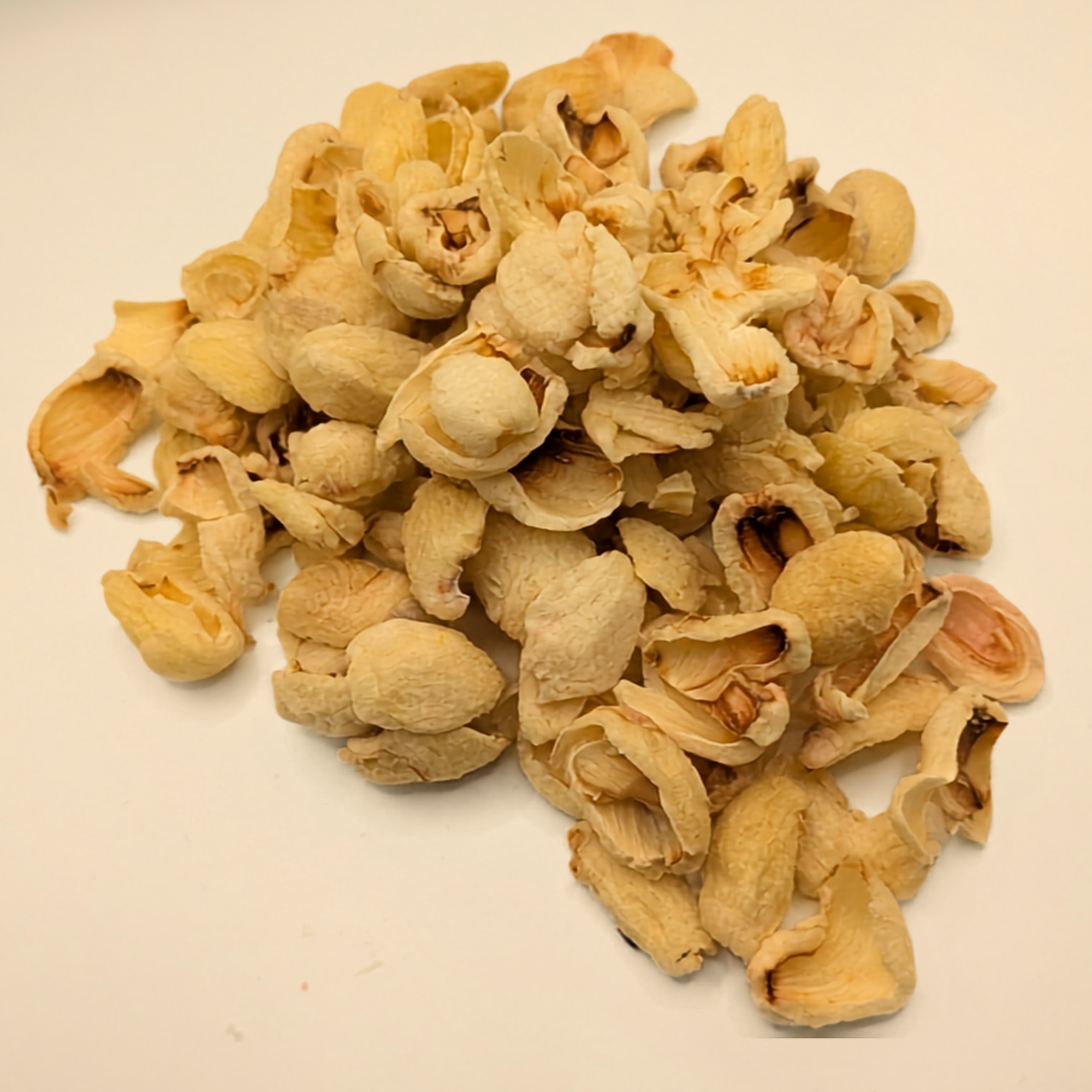 A pile of freeze dried lychee berries on a white background